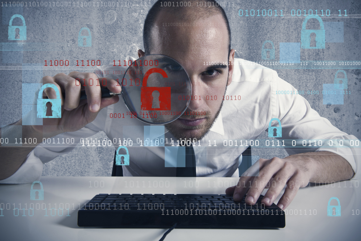 Man searching cybersecurity threats with magnifying glass