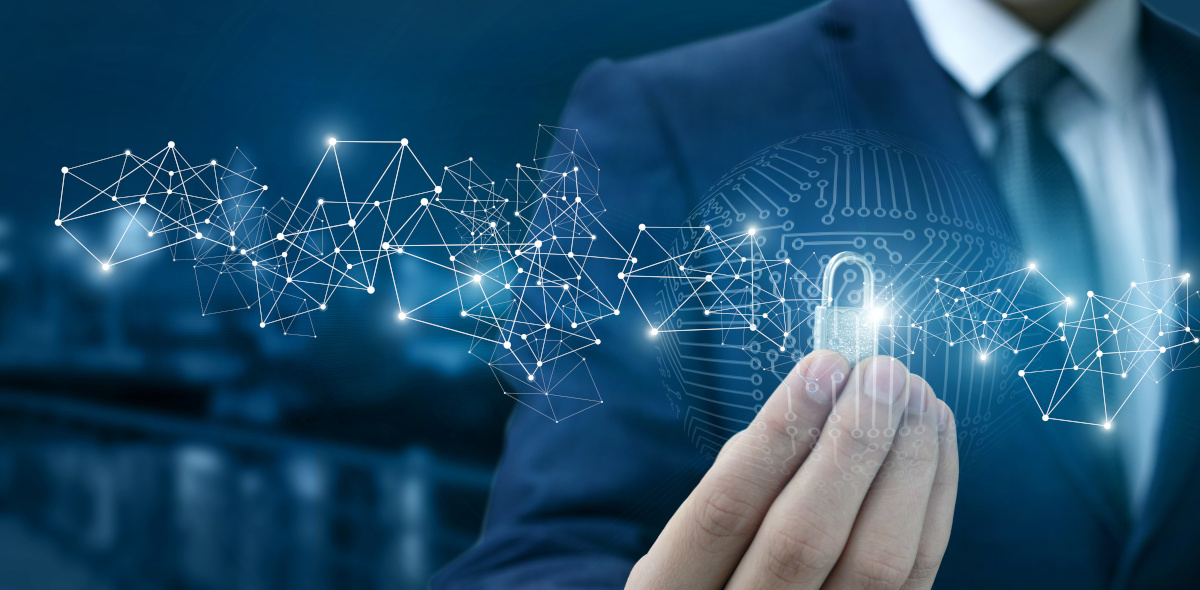 Man working on digital diagram with security padlock icon floating around