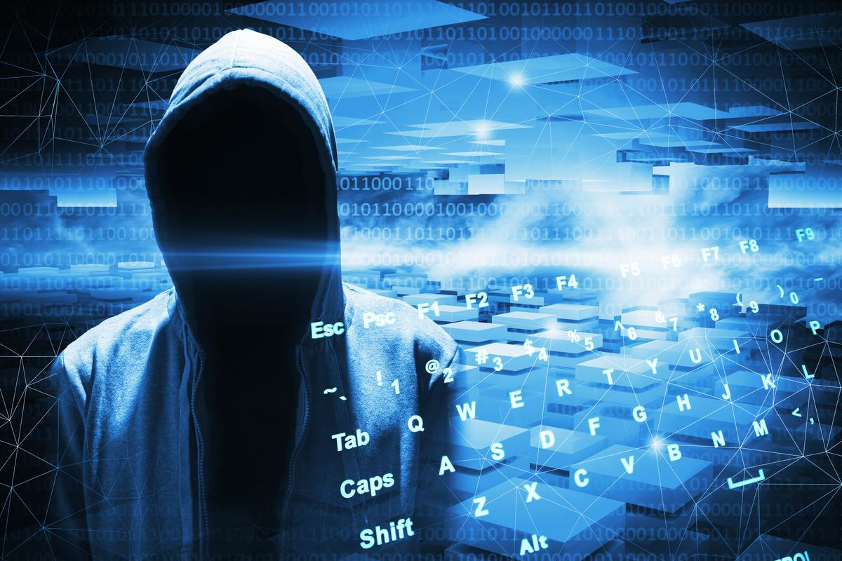 Cybersecurity concept with hacker in shadows