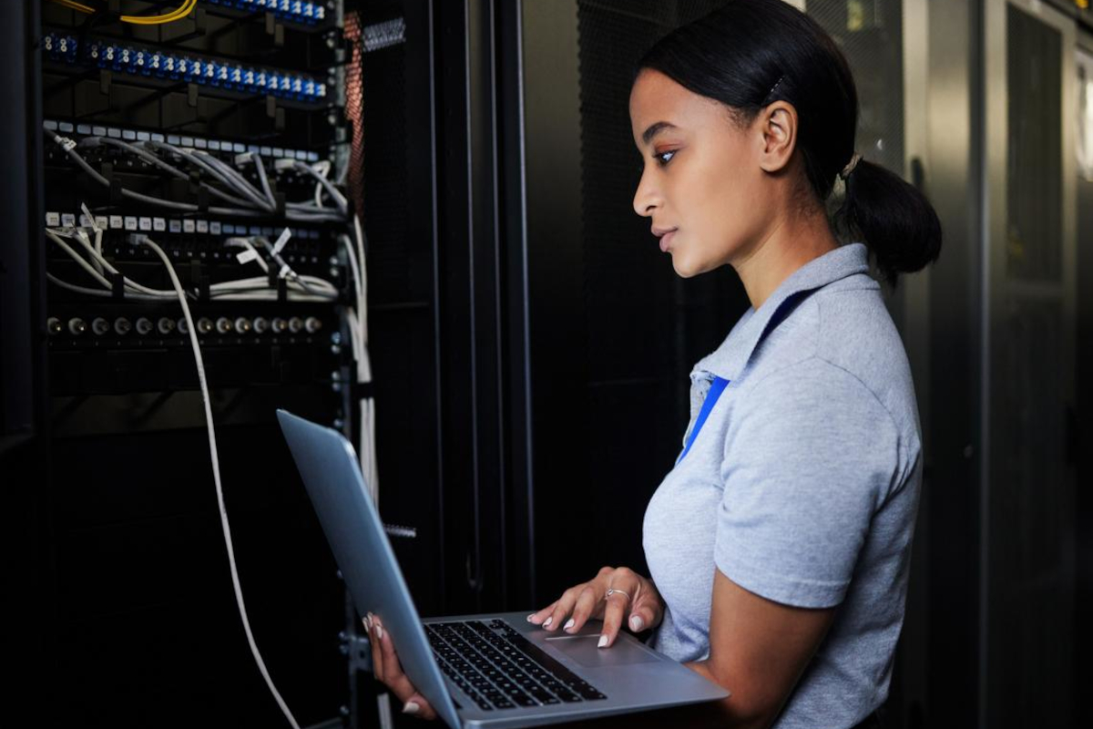 Woman checking something in server room