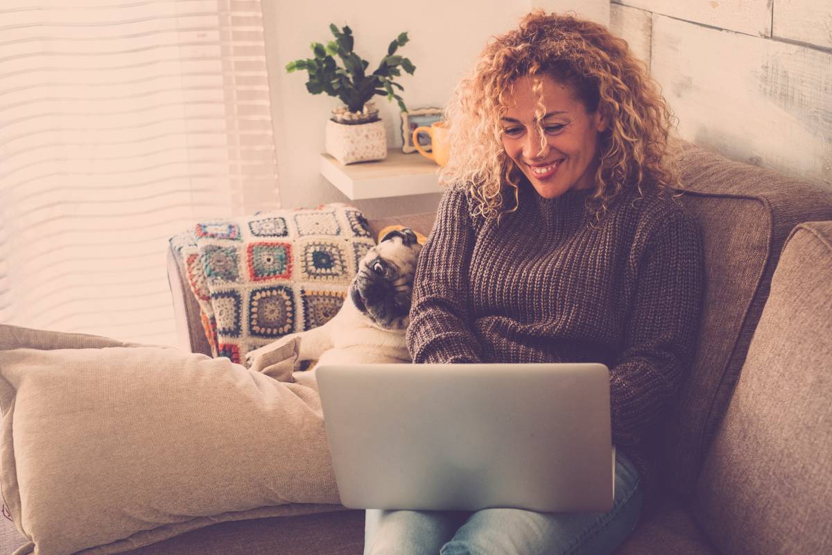 Smiling woman working on laptop