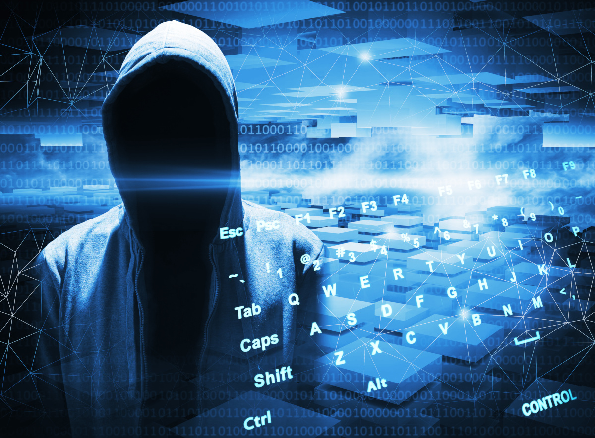 A hooded figure on in front of binary and keyboard keys